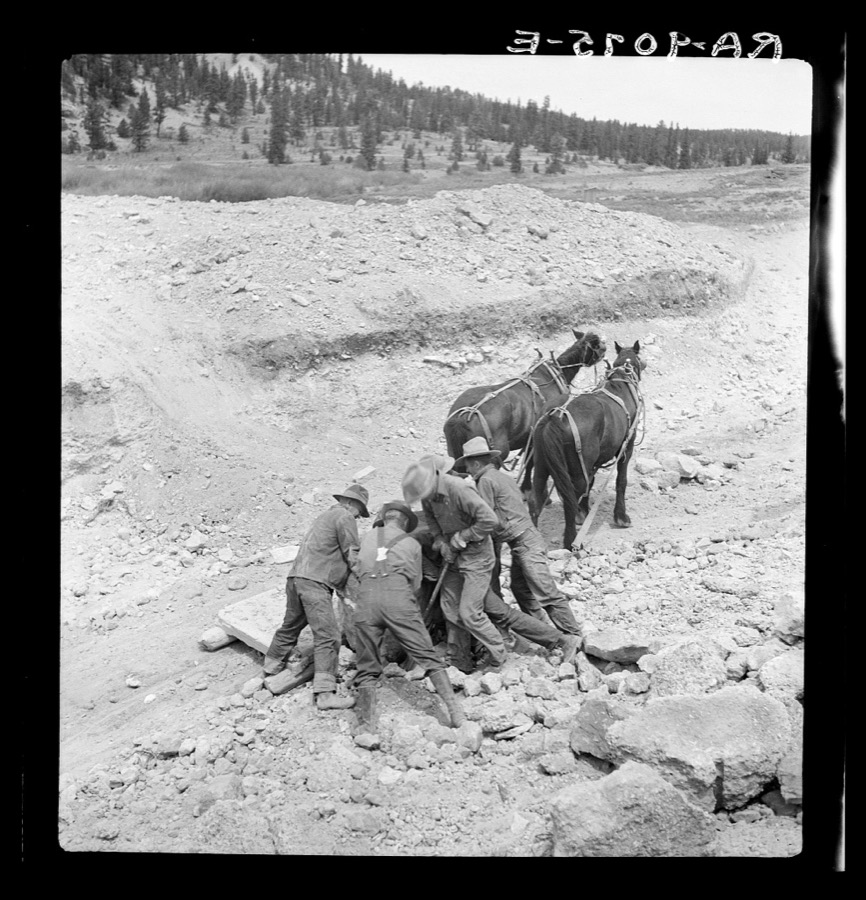 Widtsoe land use adjustment project. Garfield County, Utah. Loading boulder on stone boat, while excavating new spillway of Tropic Dam