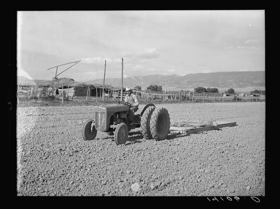 This new heavy tractor is owned by the Hansen-Frederickson Machinery Cooperative of Sanpete County, Utah. Mariel O. Hansen drives the tractor purchased with the aid of a Farm Security Administration Community and Cooperative Service loan