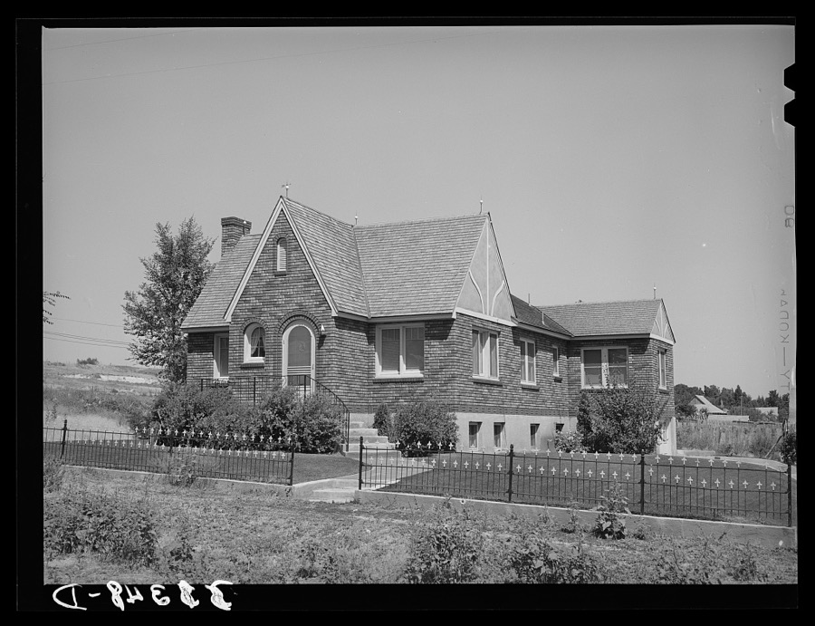 Houses belonging to a Mormon farmer in Mendon, Utah. The new house was built with profits from his farm