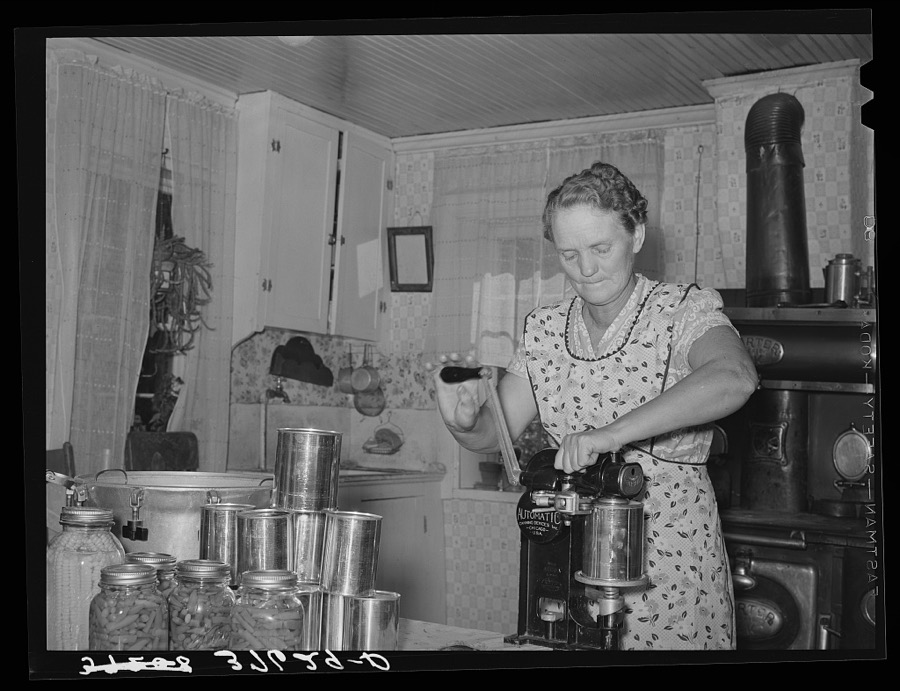 Mrs. Christiansen of the Christiansen canning unit sealing cans. During 1939 she canned 2300 quarts which included 20 mutton, 2 beeves, 5 pigs. Fish was tried very successfully. In this cooperative agreement, there were twenty-five users and outside of the cooperative there were ten others who used Mrs. Christiansen's services