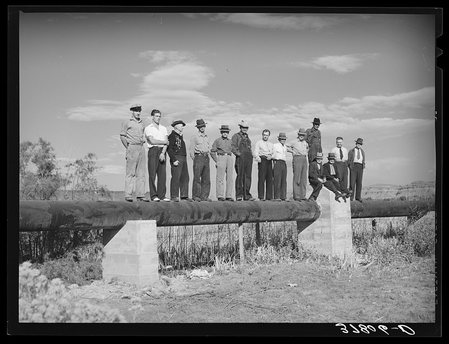 Member of FSA (Farm Security Administration) cooperative pipe line used for irrigation purposes. Saint George, Washington County, Utah