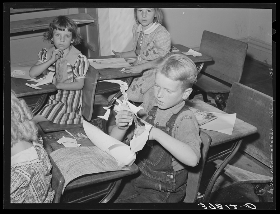 Grade school pupil making a cut-out, Santa Clara, Utah. See general caption