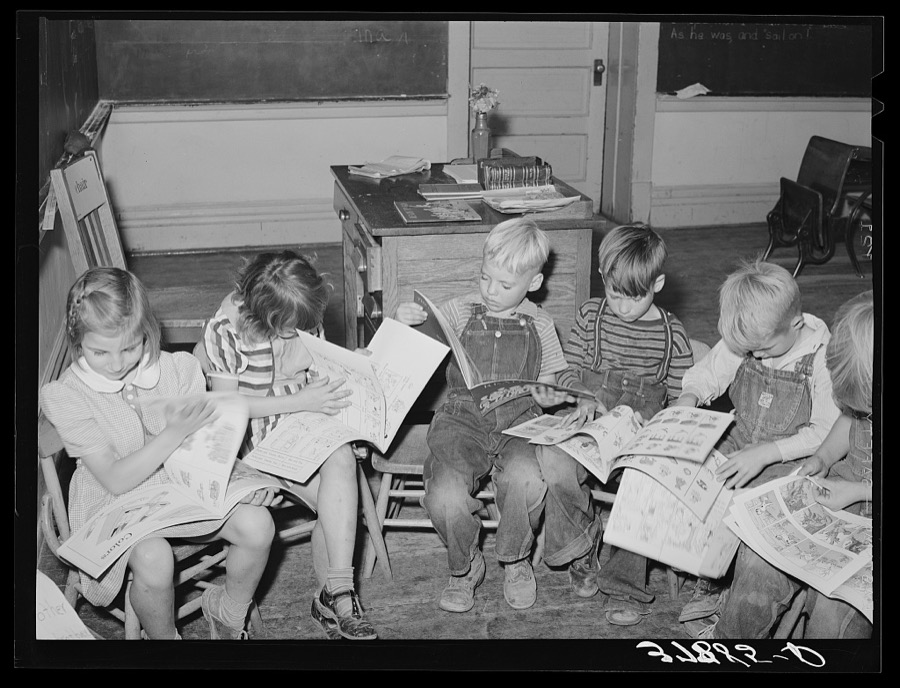 Children looking at picture books at school, Santa Clara, Utah. See general caption