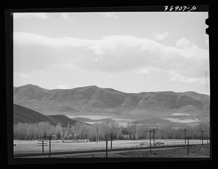 Fields extending into the mountains. Henefer, Utah. Mormon farmers in this section not only practice irrigation but take advantage of as much of all natural runoff from the mountains as possible