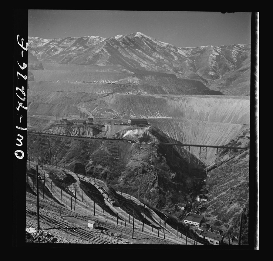Bingham Canyon, Utah. Overall view of an open-pit mine of the Utah Copper Company showing railroads, buildings, trestle bridge, and mountains of ore