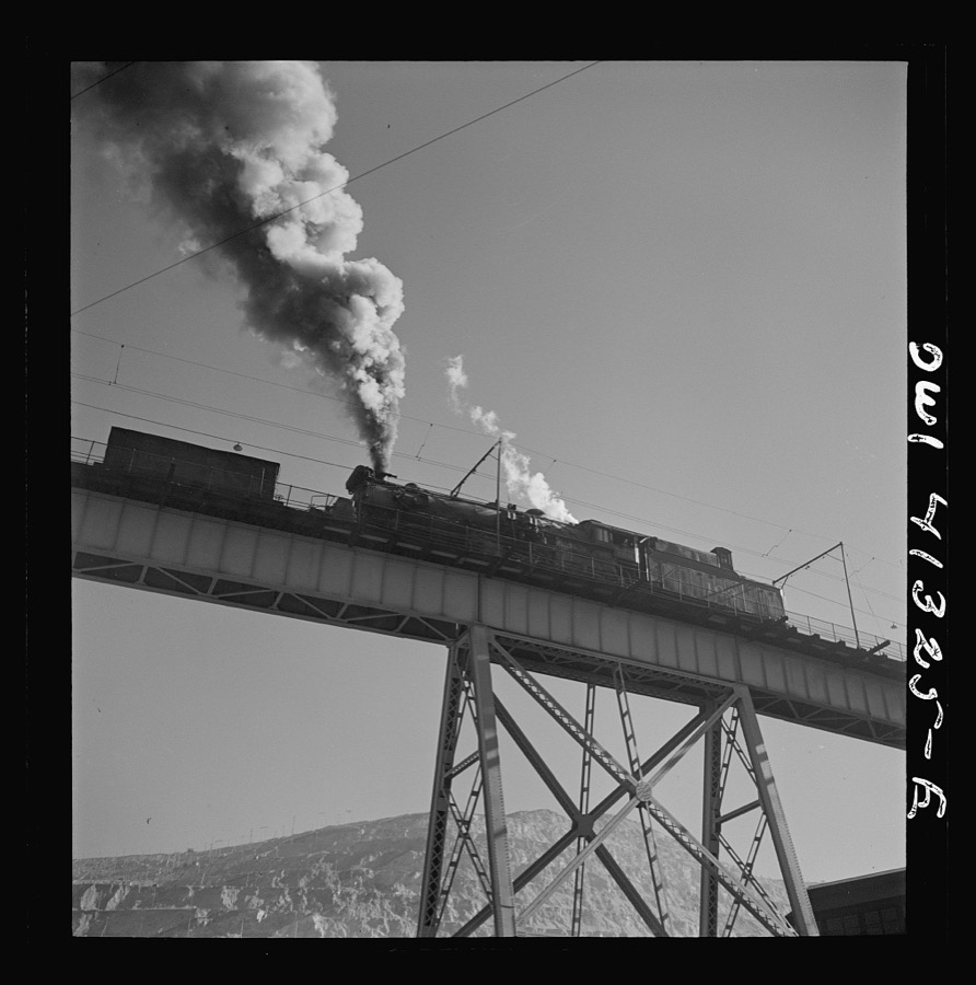 Bingham Canyon, Utah. Ore trains on a trestle bridge above an open-pit mine of the Utah Copper Company