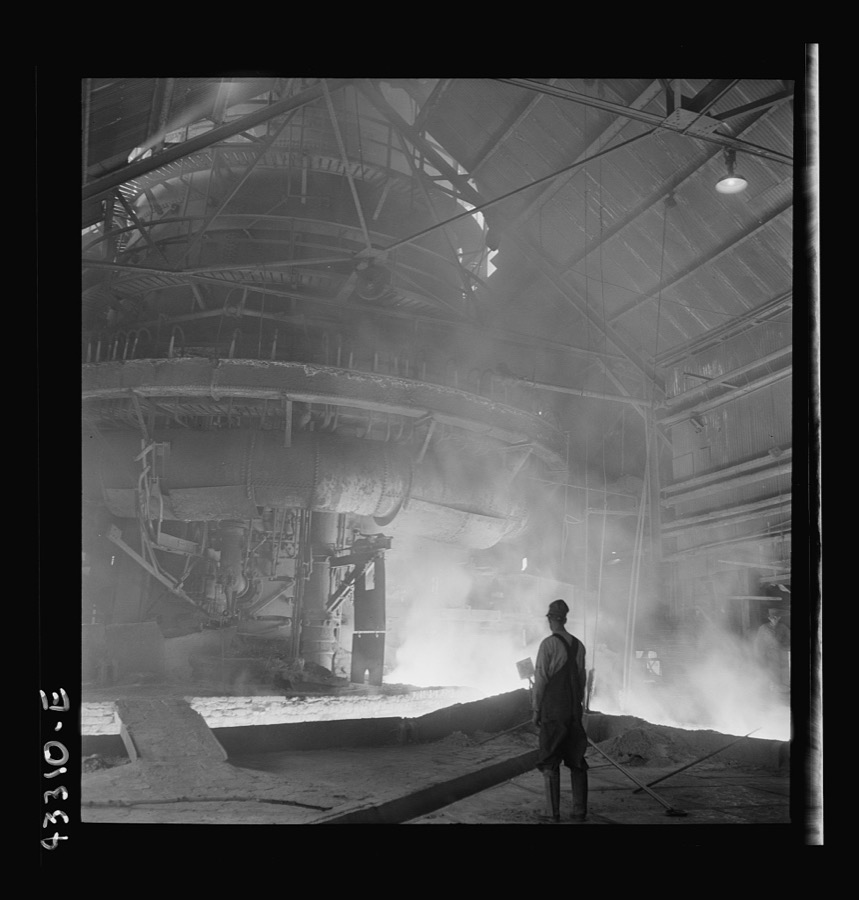 Columbia Steel Company at Ironton, Utah. Tapping a heat of iron in the cast house of the blast furnace