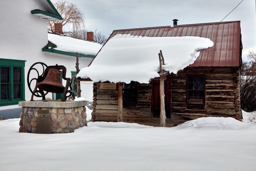 Blacksmith shop and a vintage schoolhouse bell outside the Mt. Pleasant Pioneer Museum and Relic Home in the small central-Utah city (population c. 3,500) of Mt. Pleasant