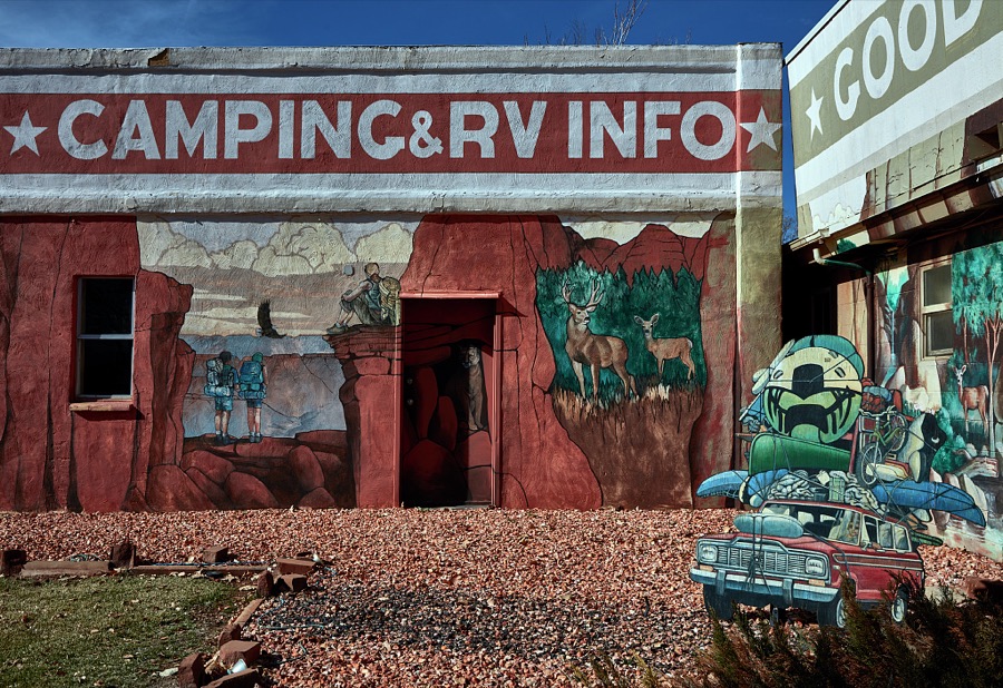 The Kane County Tourism Office in Kanab, a small city on the Arizona border in southern Utah, doesn't just talk or give visitors brochures about the town's rich history as the gathering place for producers, actors, and crews producing iconic western movies in the colorful canyons nearby, it illustrates that tradition on its exterior walls too