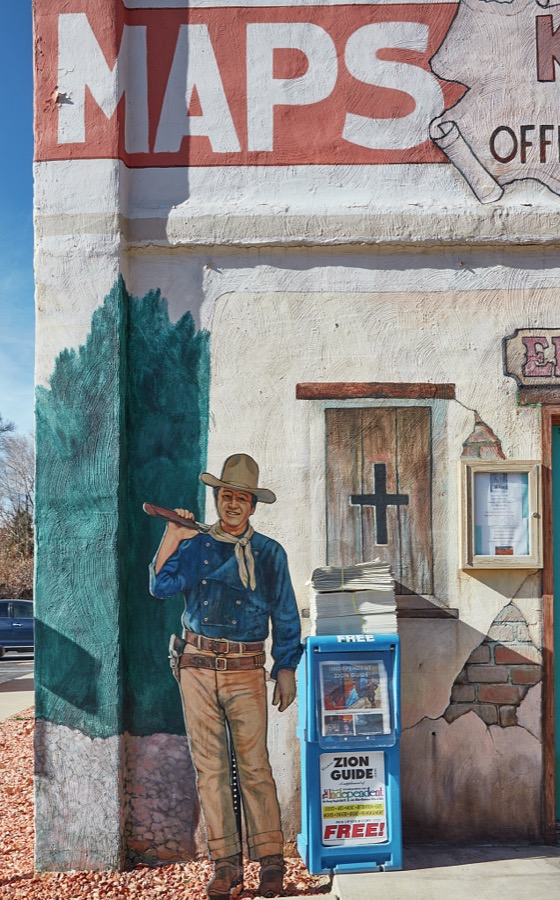 The Kane County Tourism Office in Kanab, a small city on the Arizona border in southern Utah, doesn't just talk or give visitors brochures about the town's rich history as the gathering place for producers, actors, and crews producing iconic western movies in the colorful canyons nearby, it illustrates that tradition on its exterior walls too