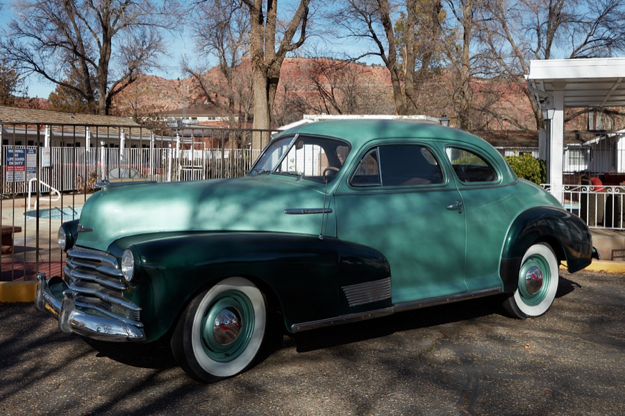A classic, vintage Chevrolet coupe attracts admirers outside the Parry Lodge in the Utah city of Kanab, on the Arizona border