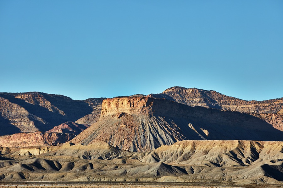 The low, wrinkly hills are devoid of much vegetation in this remote, mostly dry valley near the small city of Green River (population c. 950 as of 2022) in the western U.S. state of Utah