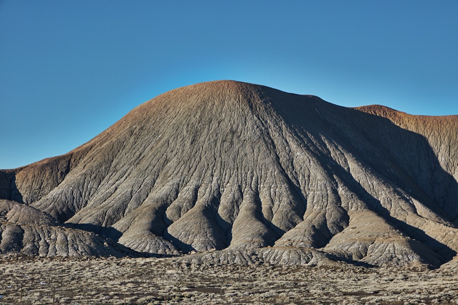 The low, hills in this remote, mostly dry valley near the small city of Green River (population c. 950 as of 2022) in the western U.S. state of Utah have the wrinkly appearance of an elephant's hide