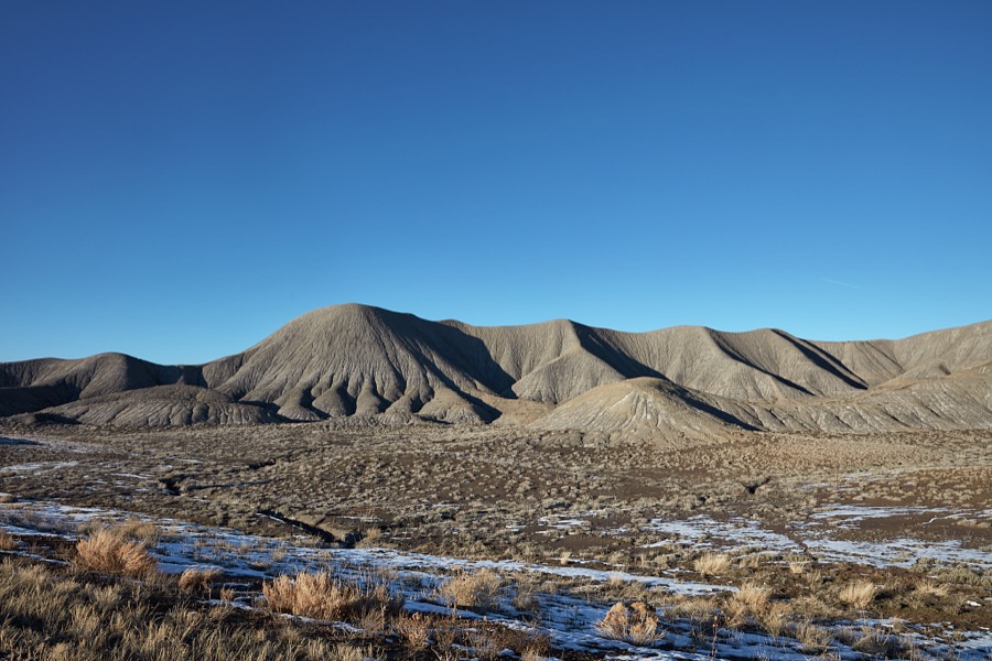 The low, hills in this remote, mostly dry valley near the small city of Green River (population c. 950 as of 2022) in the western U.S. state of Utah have the wrinkly appearance of an elephant's hide