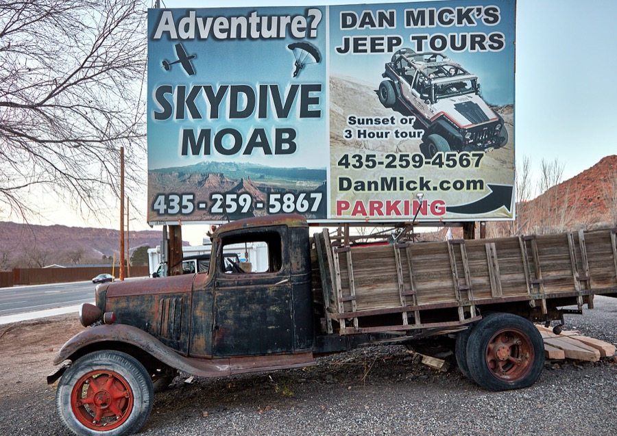 The vehicles one would take on this advertised tour near Moab, the gateway city to the stunning red-rock formations of Arches and Canyonlands national parks and other archeologically rich areas near the Colorado border in the western U.S. state of Utah, would be much more current and rugged than the old truck parked below the tour sign
