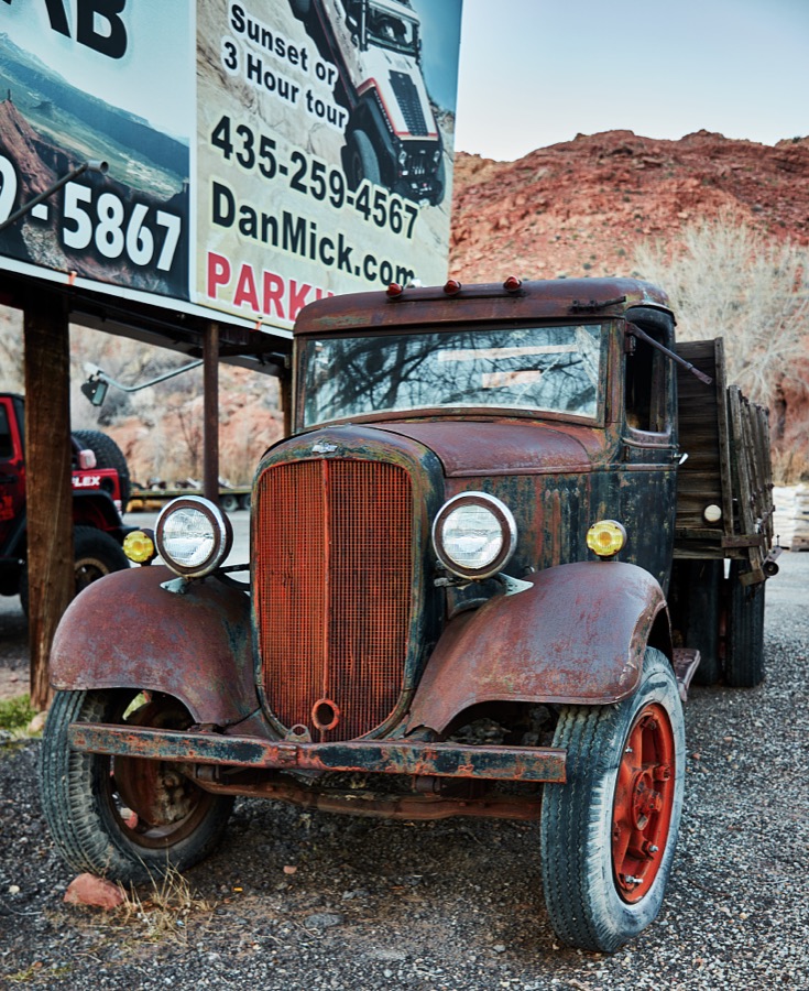 The vehicles one would take on this advertised tour near Moab, the gateway city to the stunning red-rock formations of Arches and Canyonlands national parks and other archeologically rich areas near the Colorado border in the western U.S. state of Utah, would be much more current and rugged than the old truck parked below the tour sign