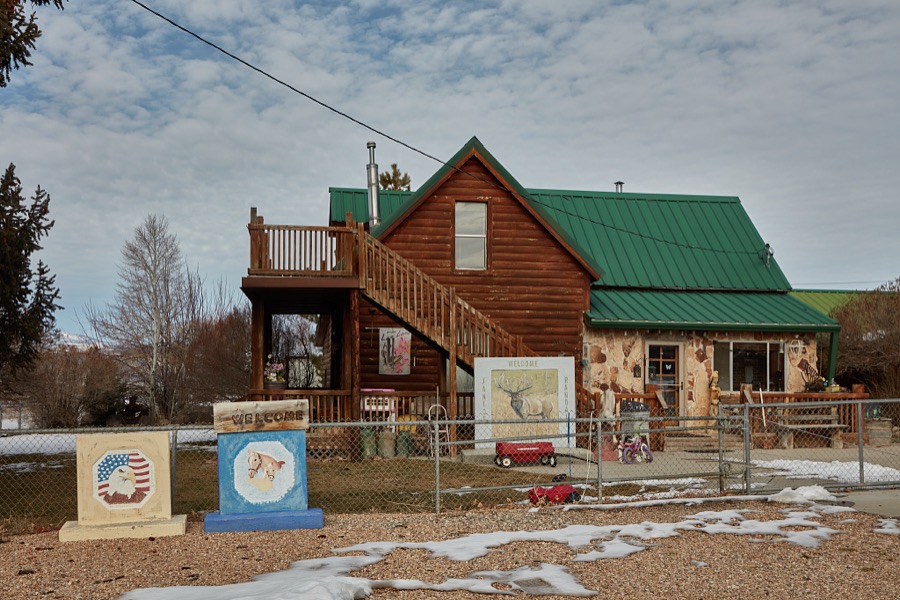 Welcome signs with outdoor themes dominate the decorations outside a modest home in the little town of Sterling in south-central Utah