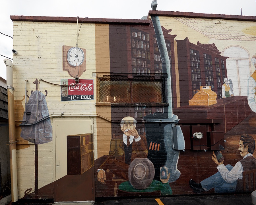 Half of a building-wide, intricate, elaborately painted mural depicting a scene inside an old-fashioned soda fountain in the small central-Utah city (population c. 3,500) of Mt. Pleasant