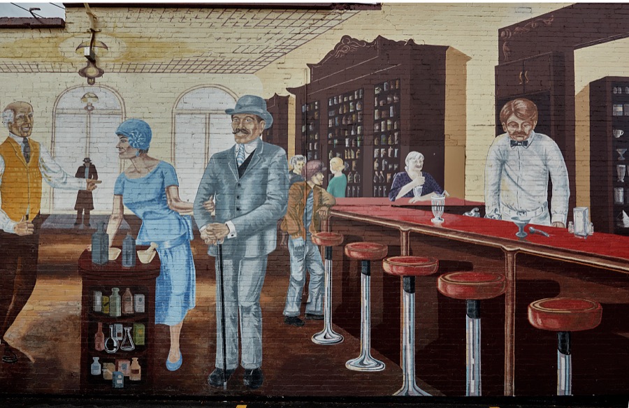 Half of a building-wide, intricate, elaborately painted mural depicting a scene inside an old-fashioned soda fountain in the small central-Utah city (population c. 3,500) of Mt. Pleasant