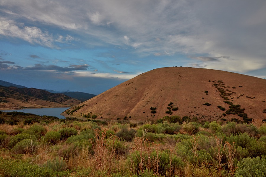 Dark skies give an extra glow to the hills above Deer Creek Reservoir, near Wallsburg in Wasatch County, Utah