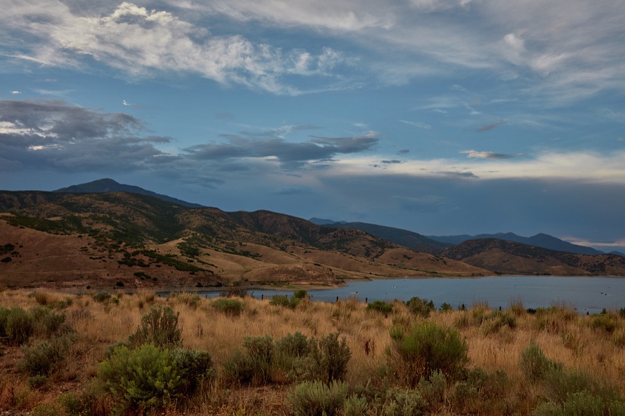 Dark skies give an extra glow to the hills above Deer Creek Reservoir, near Wallsburg in Wasatch County, Utah