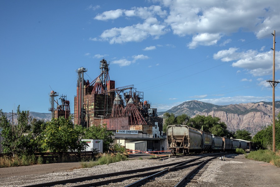 Train cars await their loads outside the Cash Commodities feed mill in Ogden, Utah